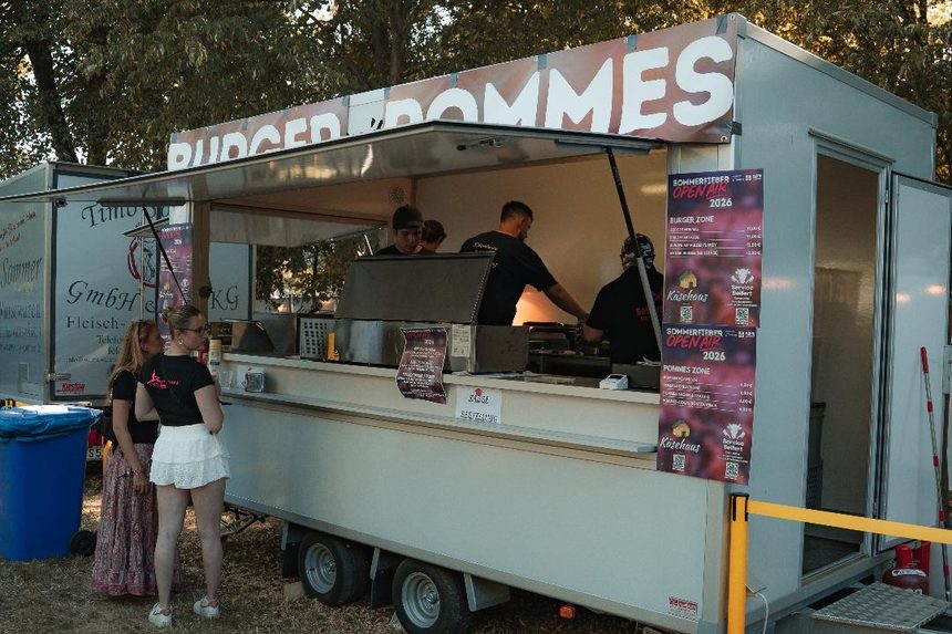 Verkaufsanhänger mit Burger- und Pommesausgabe auf dem Festgelände